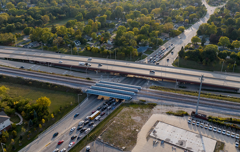 Ariel photo of new interstate interchange, with setting sun over suburban region