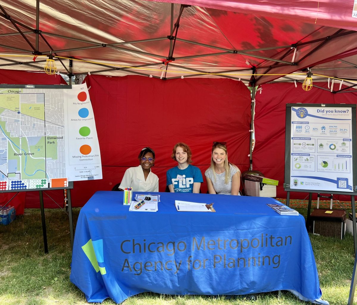 Three people sit behind CMAP table near posters about River Grove