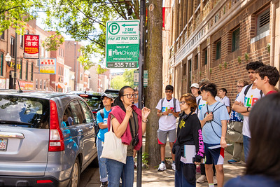 Photo of FLIP students listening to Chinatown community partner Debbie Liu