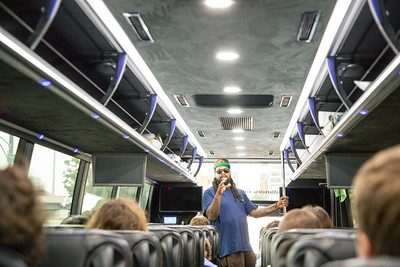 Photo of FLIP students on tour bus with guide Sherman Dilla Thomas.