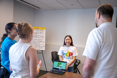 Photo of FLIP student presenting final project to CMAP staff and interns