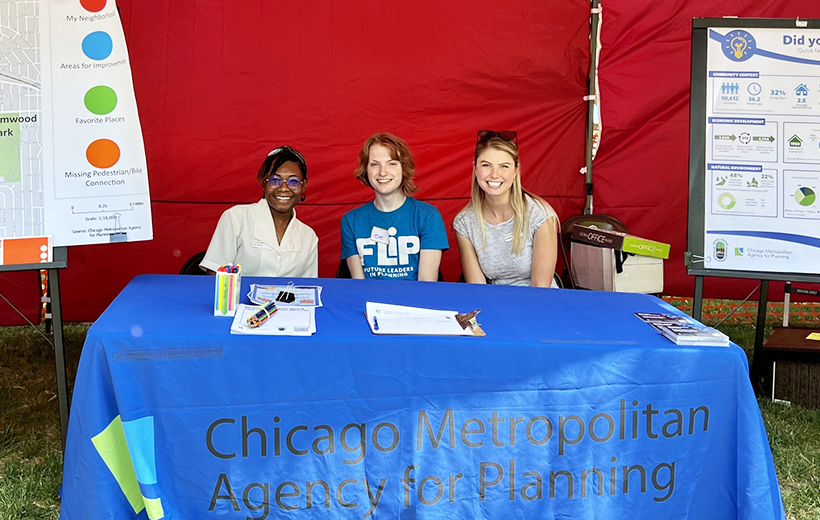 Three people sit behind CMAP table near posters about River Grove