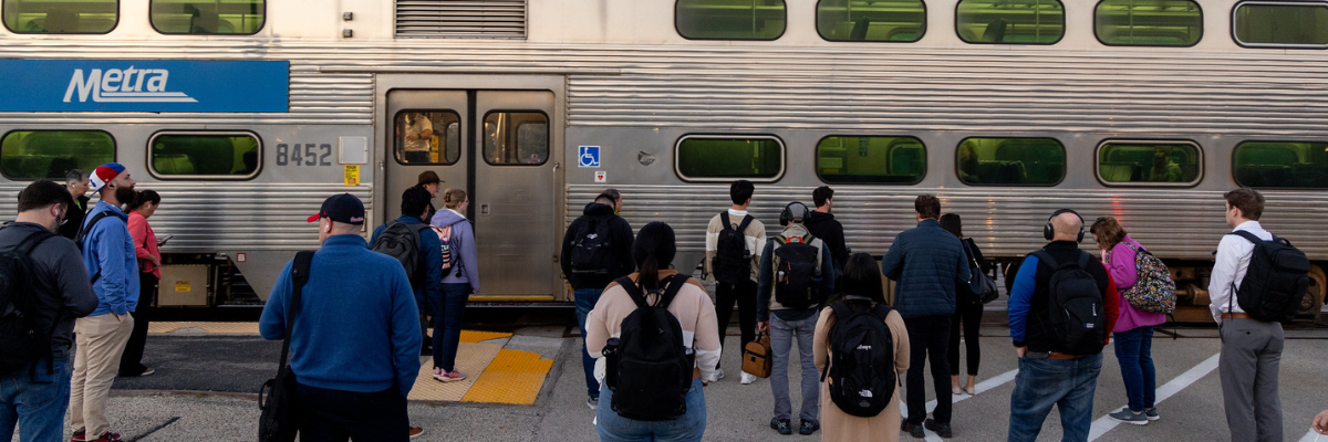 People waiting outside a Metra train