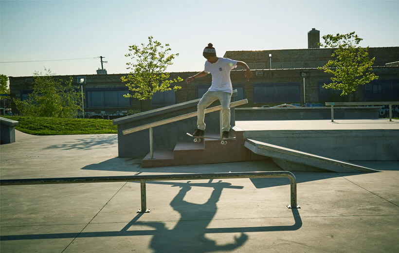 A skateboarder in the air whilst doing a trick in a skatepark.
