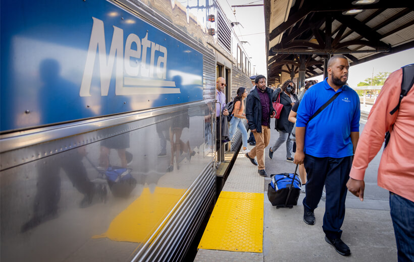 People walking off of the Metra train