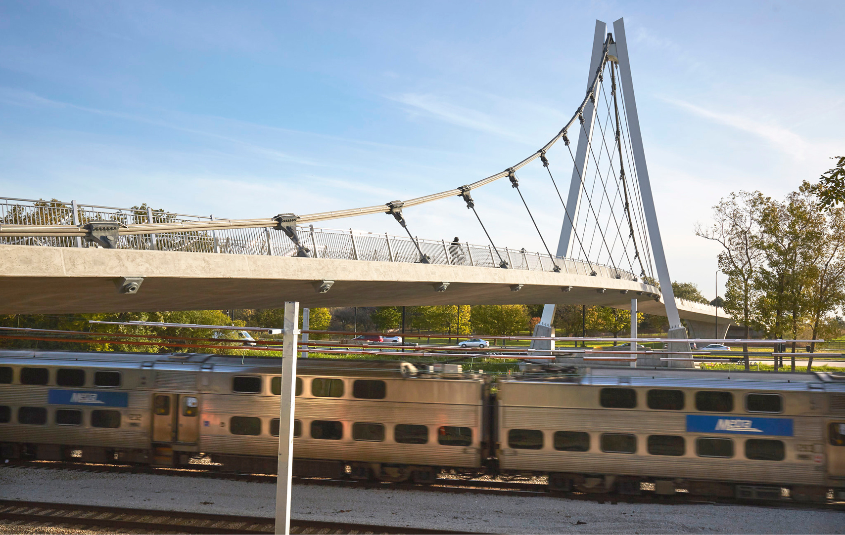Pedestrian bridge of innovative architectural design crossing Metra tracks in South Side Chicago